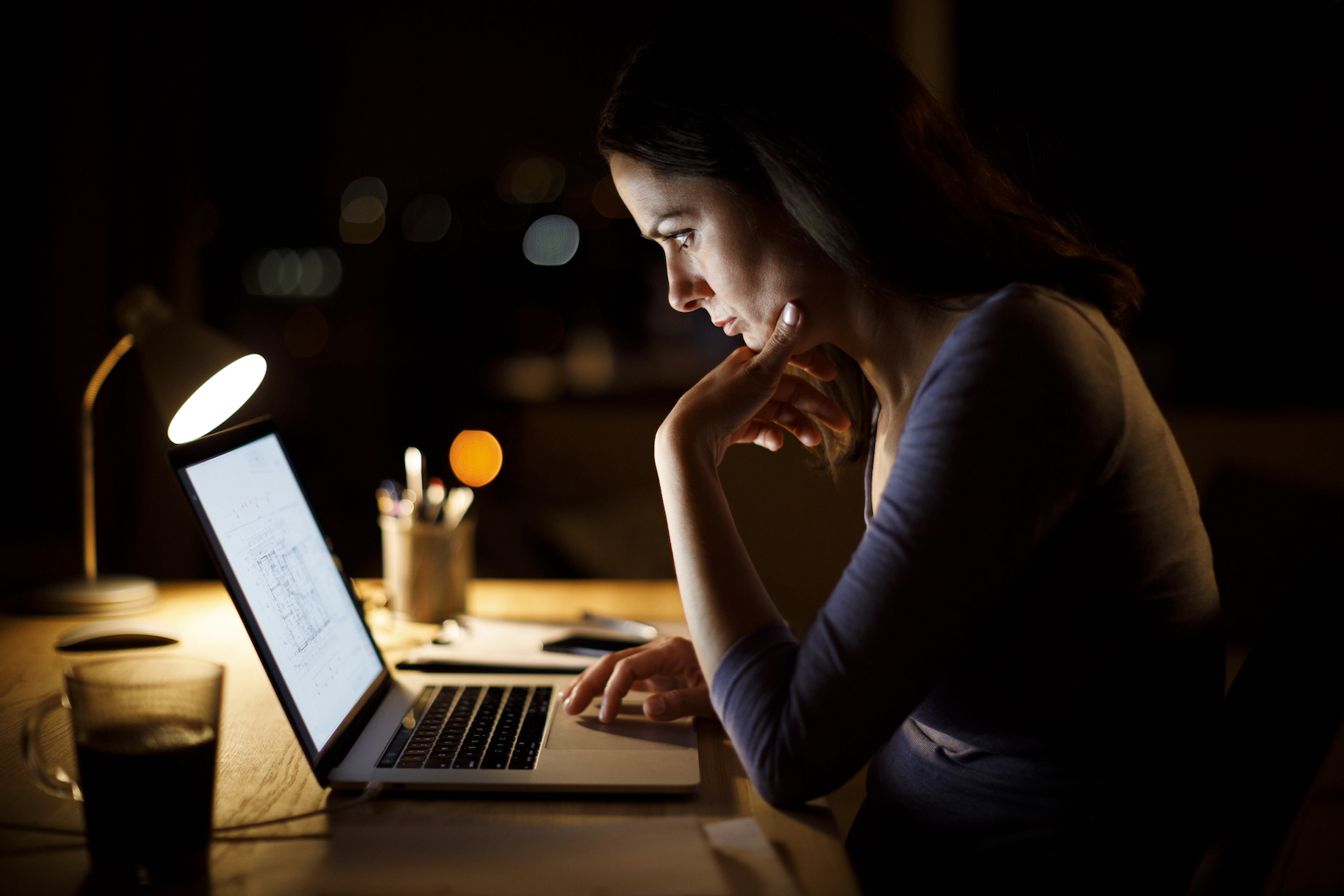 Woman Working Late At Home for article on toxic workplace.