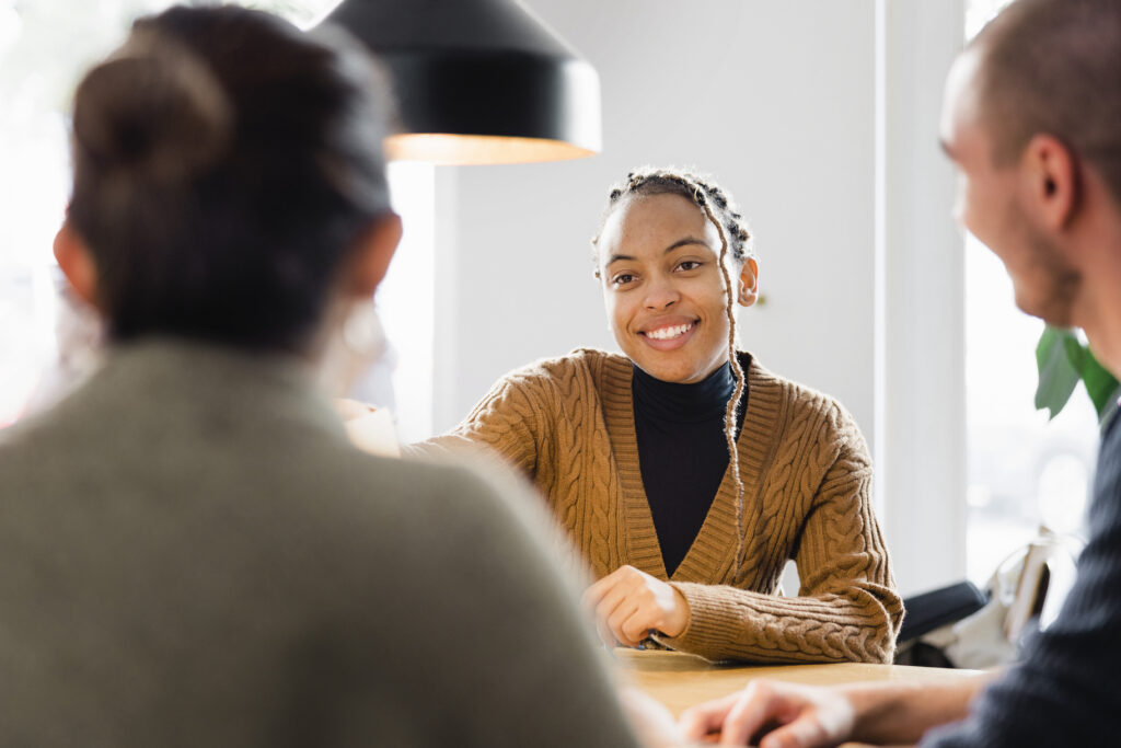 Confident Female Applicant Smiling At Job Interview with top skills on her resume