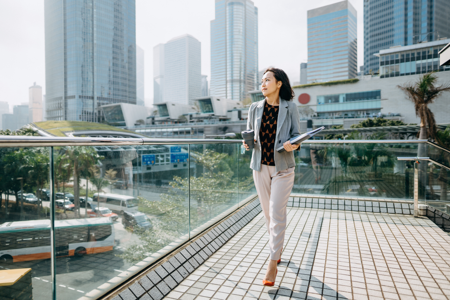Read about: Asian Businesswoman Holding Documents And Coffee By Office Buildings
