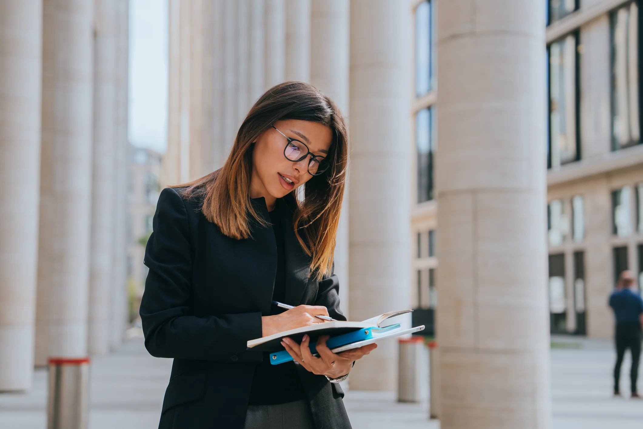 Read about: Young Adult Businesswoman In Black Jacket Writing In Notebook Stands Outside At Huge Building, Successful Female Lawyer Makes Note At Court Building, Prepares For Meeting With Client.