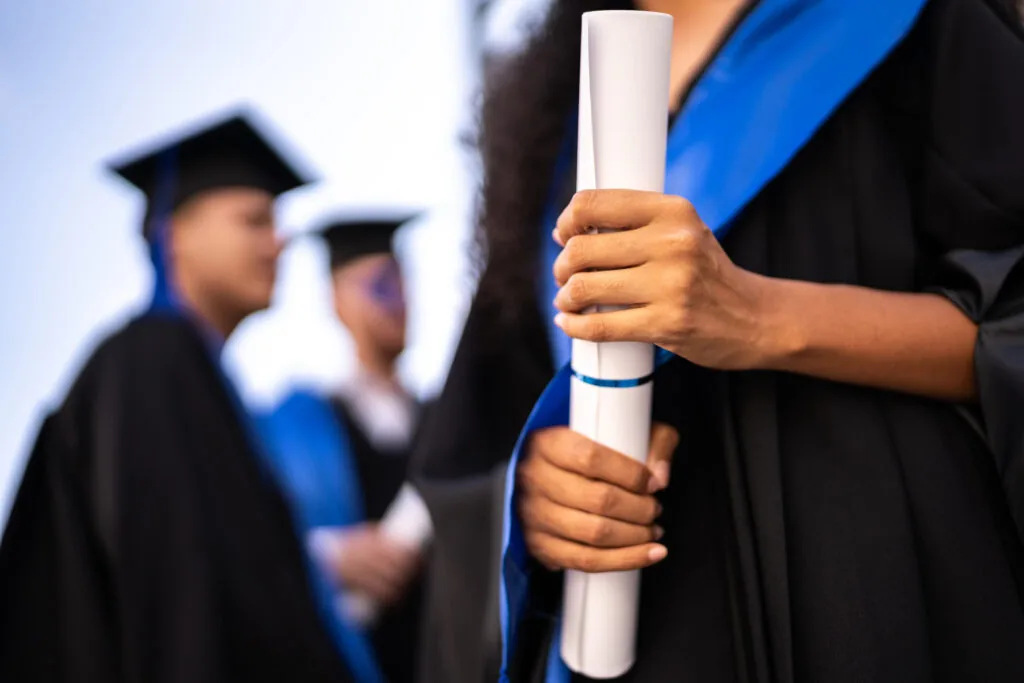 Close Up Of A Young Woman Holding A Diploma On Graduation