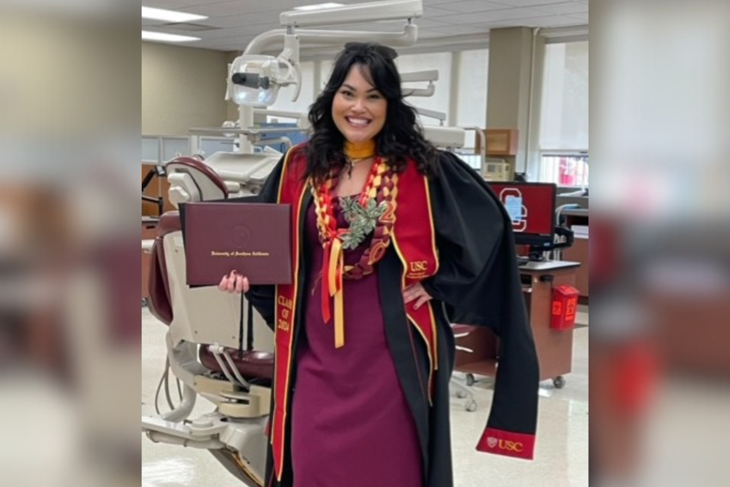 Read about: Maya Fulcher stands with her diploma in a USC dental office.