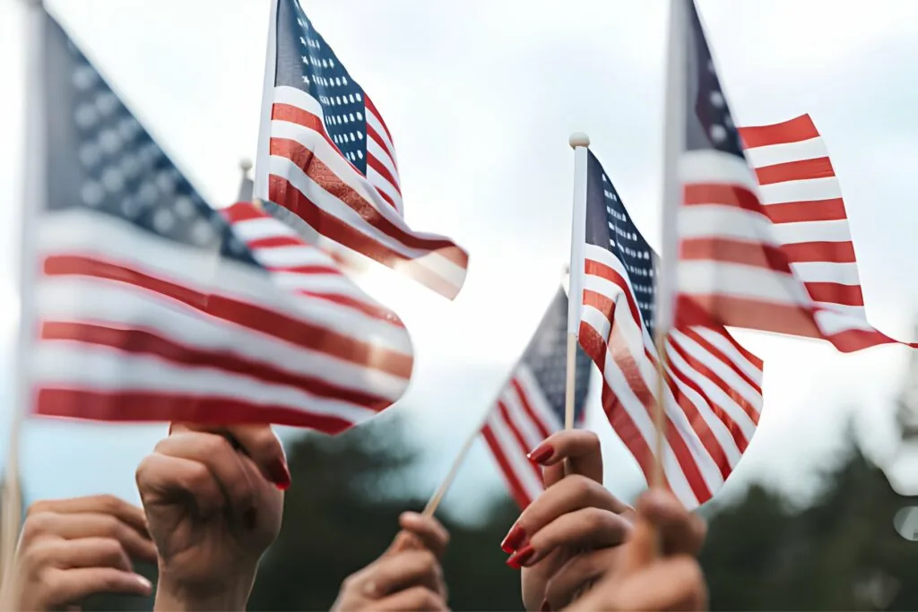 Crowd of people holding American flags as veterans transition from military to civilian life