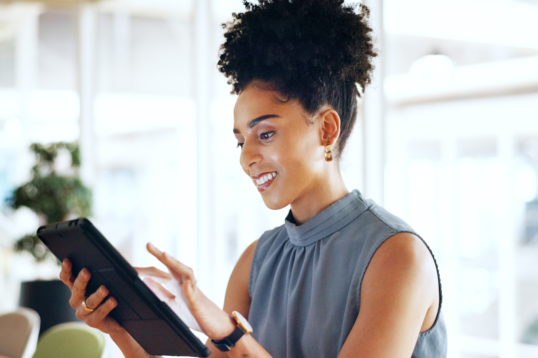 Read about: A business woman looks at a tablet she is holding. Learn how to become a UX researcher in this article.